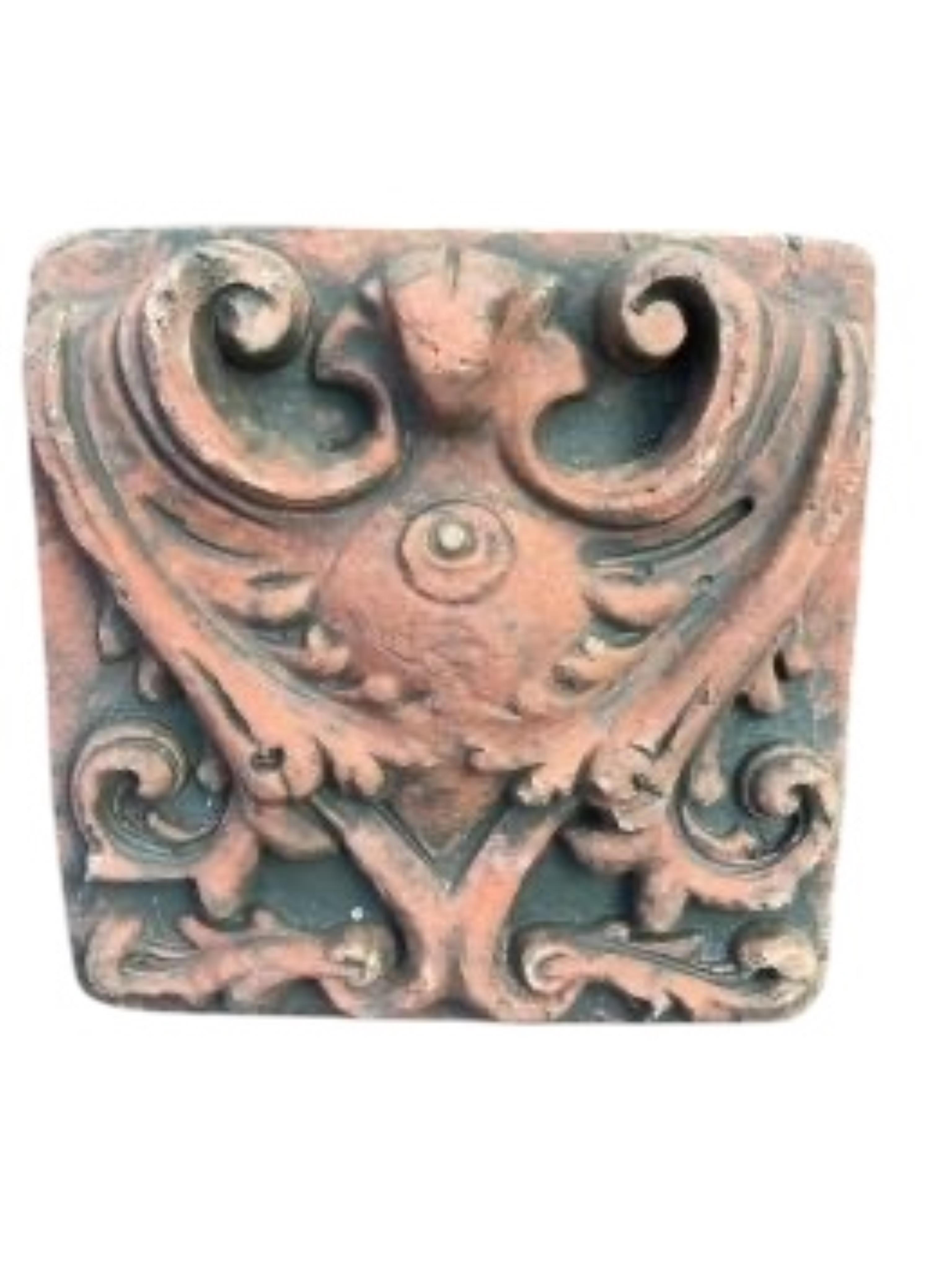 A Gothic style cast stone garden wall plaque and a terracotta tile, larger width 56cm, height 58cm
